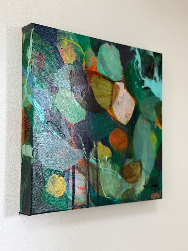 Abstract painting on a wall with green and blue tones