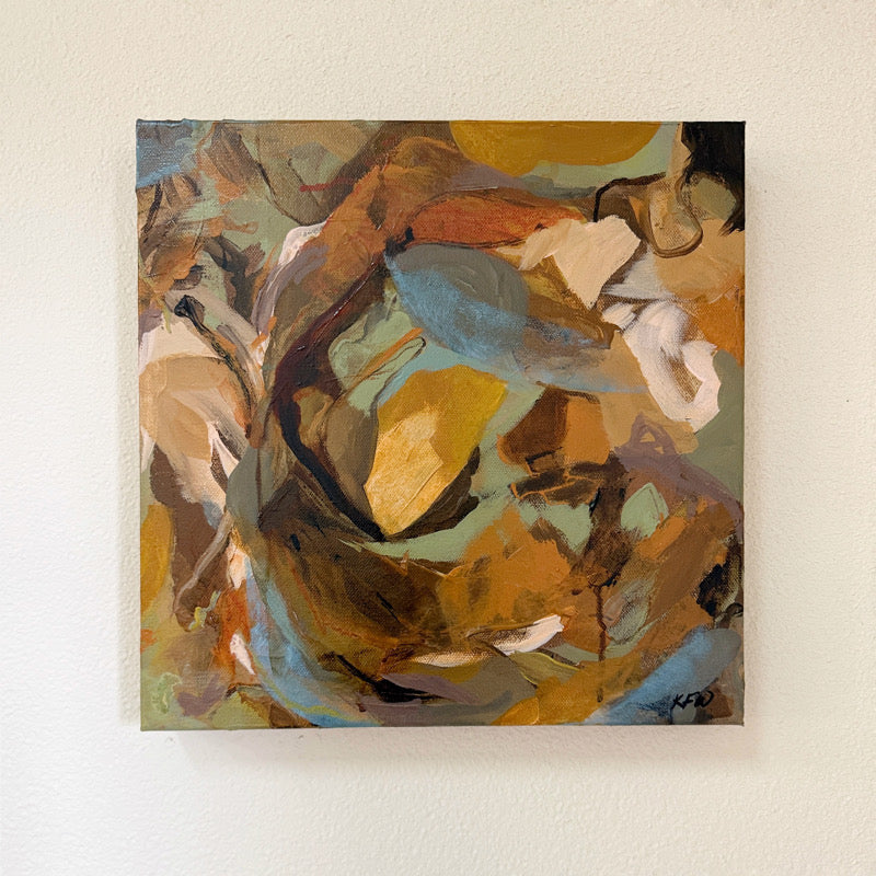 Abstract painting with swirling colors on a beige wall.