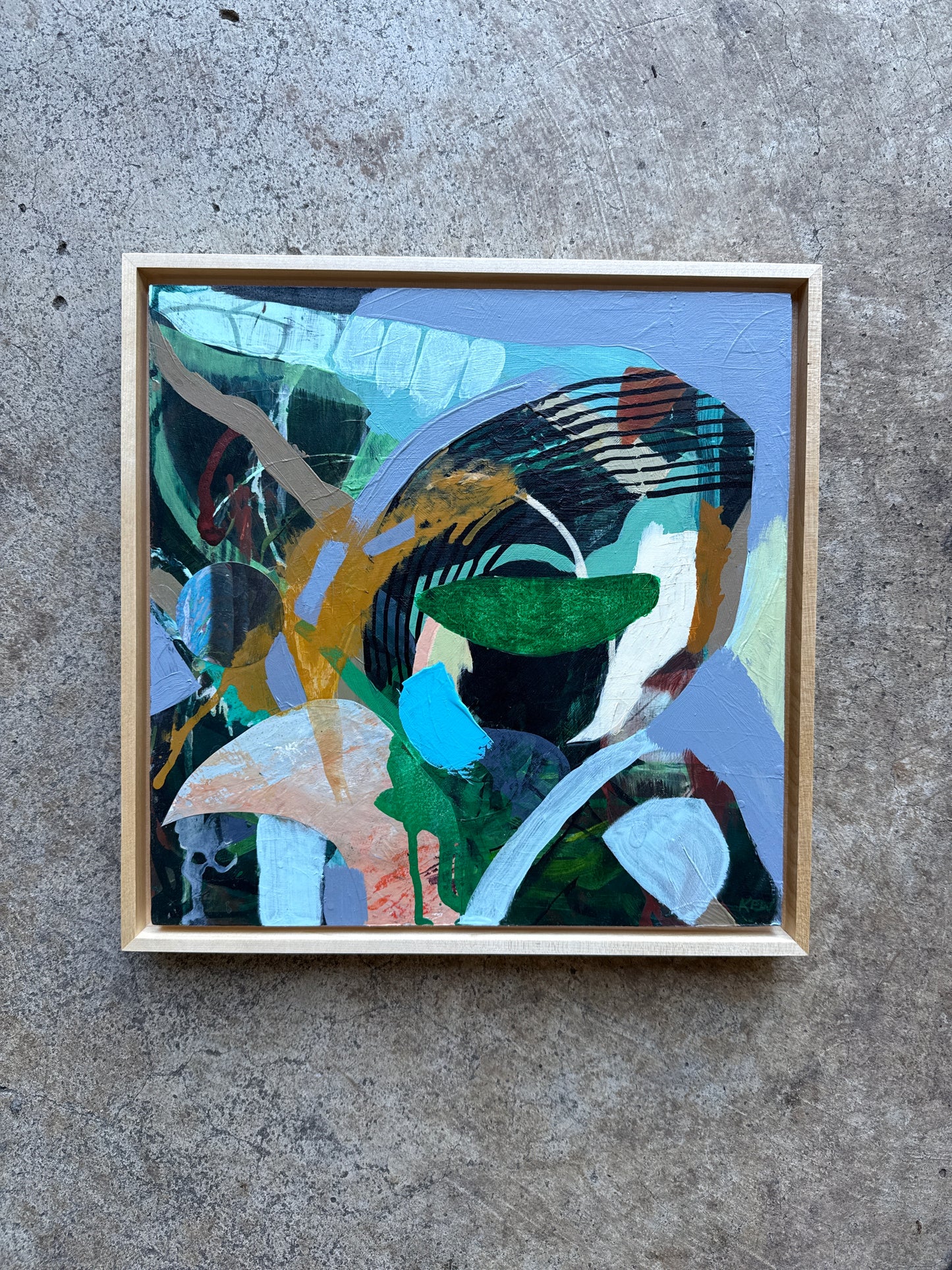 Framed abstract painting on a concrete surface