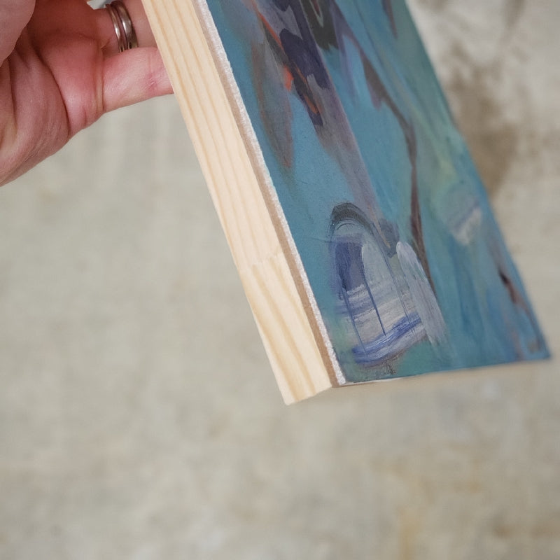 Photo showing light wood cradled panel side view of "Barrio Cart" abstract artwork by Kasey Wanford