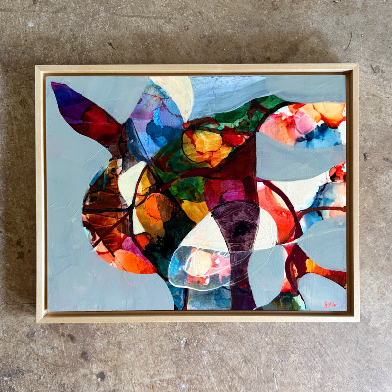 Colorful abstract painting  in a wooden frame on a textured surface