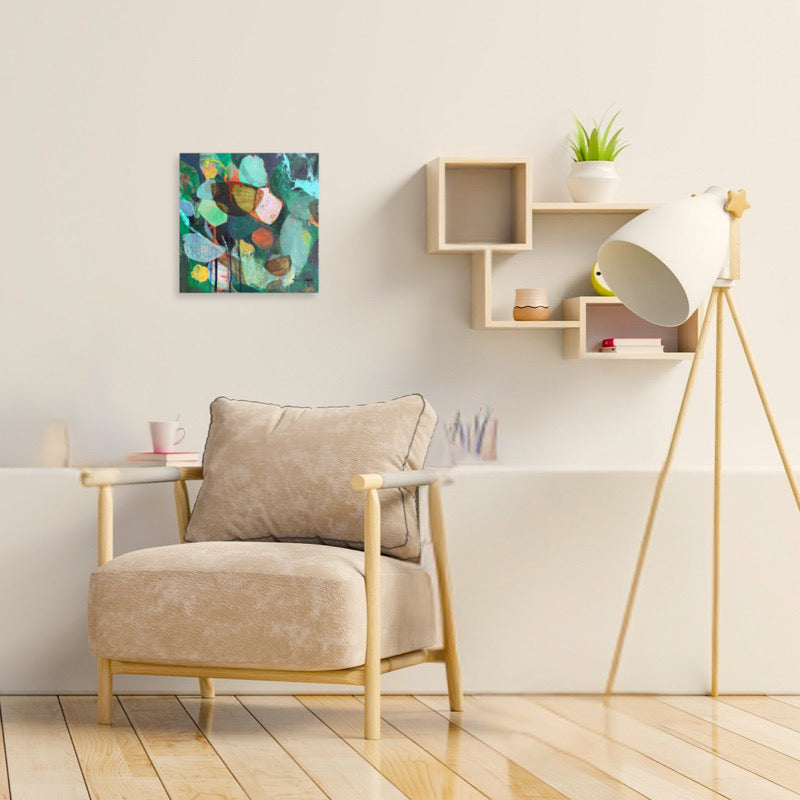 Beige armchair in a modern living room with a lamp and wall art.