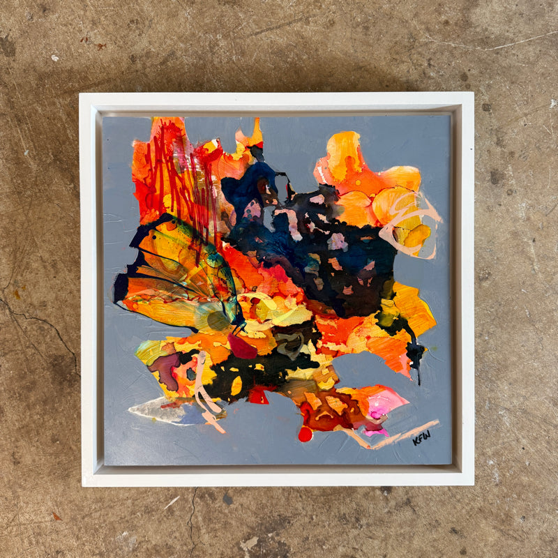 Framed abstract painting with vibrant colors on a textured surface