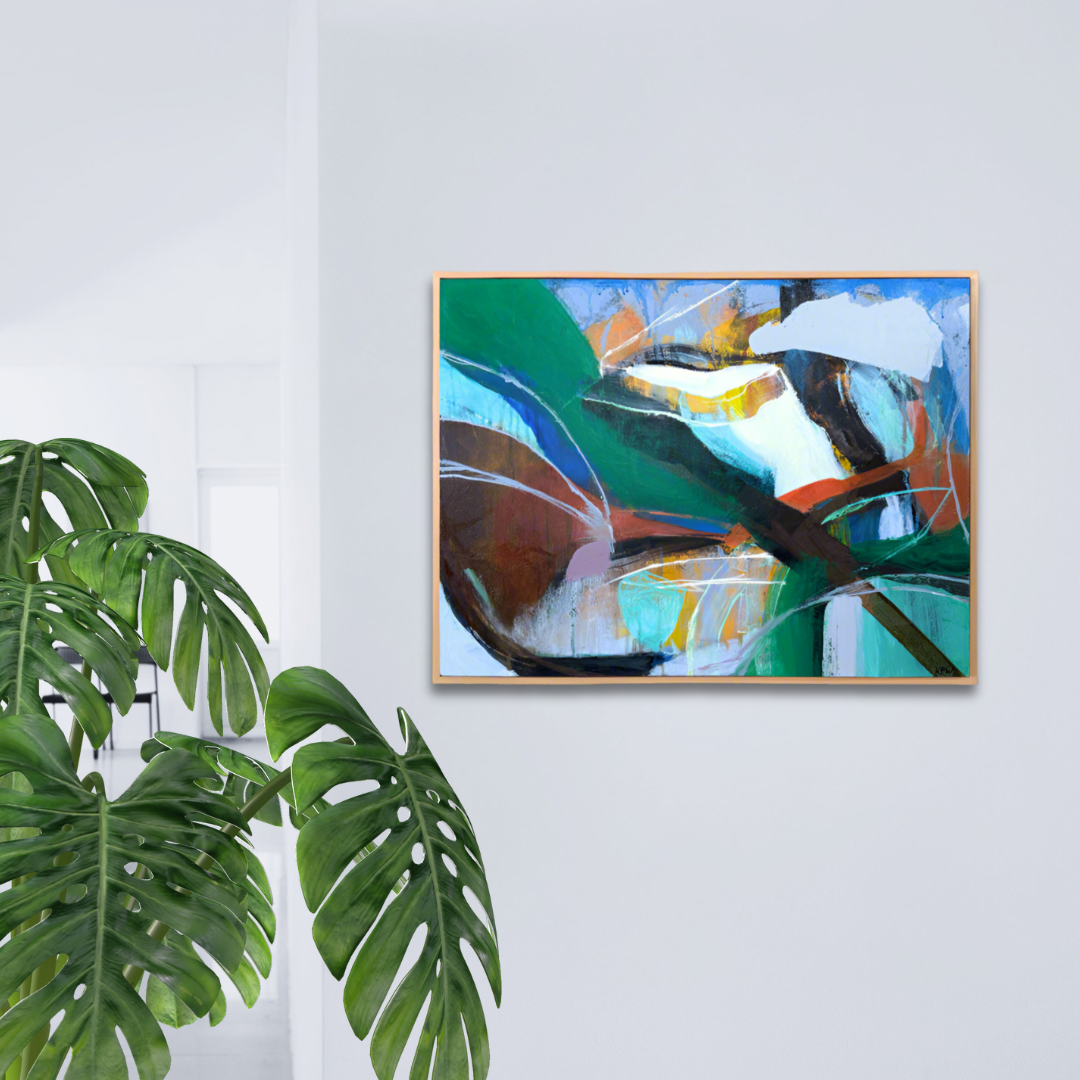 Medium size framed abstract painting on wall with plant